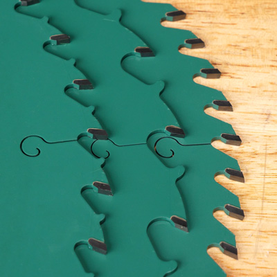 three grizzly pro blades stacked on a workbench, showing different tooth configurations